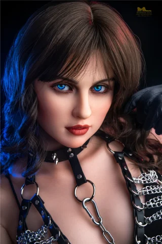 Doll with blue eyes wearing a black leather outfit and a choker, posing with a dramatic lighting effect.