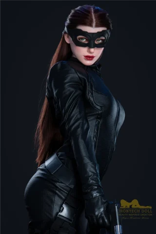 Hazel S18 166cm B Cup Irontech dressed in a black catsuit with a mask, holding a gun, set against a dark background.