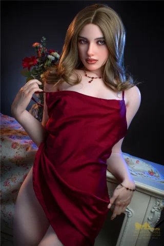 Hazel S18 166cm B Cup Irontech doll wearing a red satin dress, posing with one hand on her hip and a bouquet of flowers nearby.