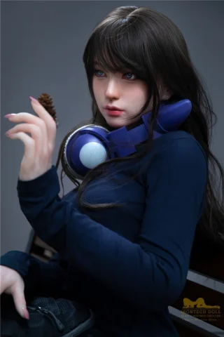 S1 166cm C Cup Irontech doll wearing a dark blue top, holding a pine cone, with headphones around her neck.