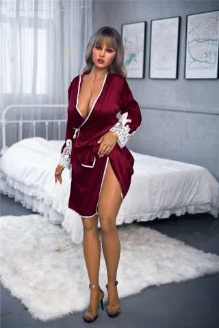 S2 165cm tan Irontech doll wearing a burgundy robe with lace details, standing in a bedroom setting.