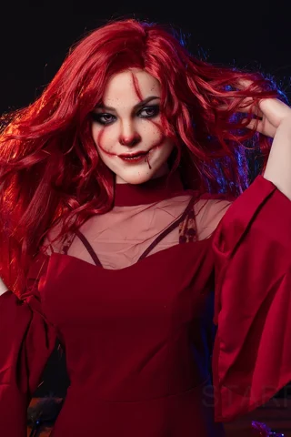 Lveinthan 169cm C Cup Starpery in a red dress with sheer sleeves, posing with long red hair against a dark background.