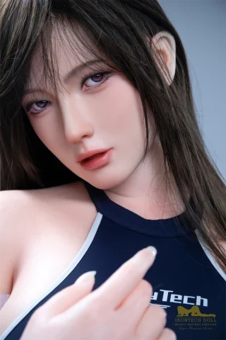 Fenny S29 164cm E Cup Irontech features long dark hair and a close-up of her face with soft makeup and a sporty outfit.