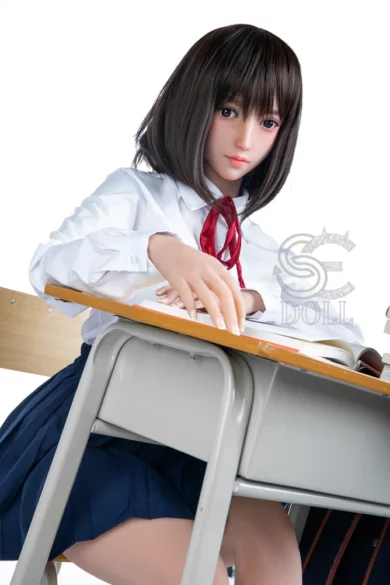 Yuuki 163cm E Cup SE Doll in school uniform sitting at desk with open book