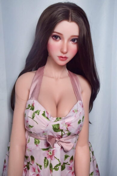 Mizushima Suzuran 165cm sex doll with long dark hair in a floral dress against a light background