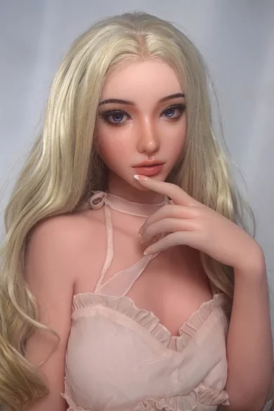 Sakai Kanako 165cm love doll with long blonde hair in a pink top, posed with one hand near face.