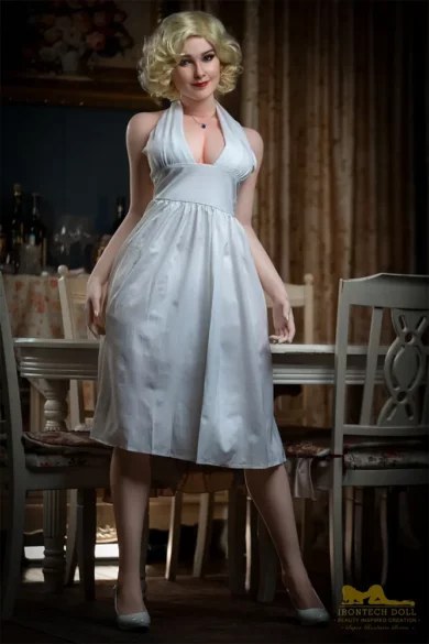 Carmel S12 164cm love doll in a white dress stands beside a vintage table and chairs in a retro-style room