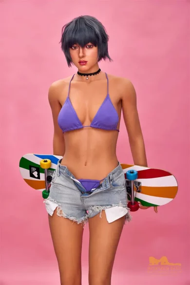 Sex doll with short hair wearing purple bikini top and denim shorts, holding a skateboard against pink background.