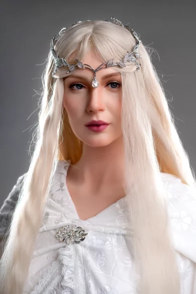 A figure with long blonde hair, wearing a silver headpiece and a white embroidered garment, resembling the GE78 175cm E Cup Zelex.