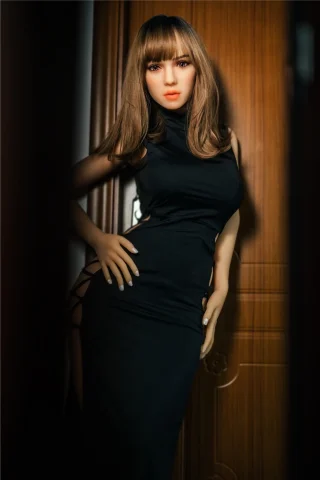 Minus Viola 160cm H Cup Irontech TPE doll in a black dress, posing with long hair against a wooden background.