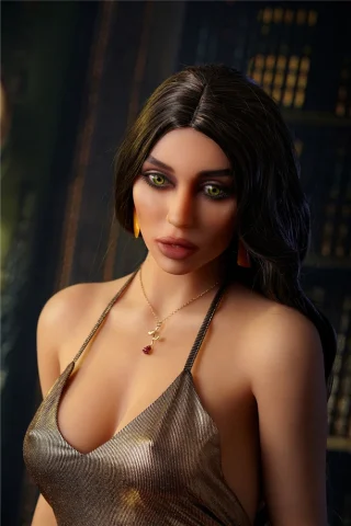 Natalia 163cm C Cup Irontech TPE wearing a shimmering gold dress, with long dark hair and striking green eyes.