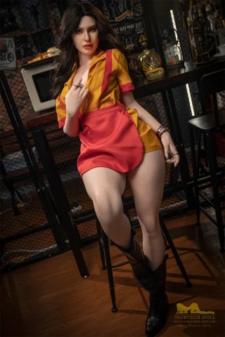 Pearl S19 164cm E Cup Irontech doll wearing a yellow and red outfit, sitting on a bar stool with cowboy boots.