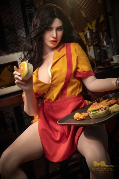 A sex doll resembling the Pearl S19 164cm E Cup Irontech, in a yellow and red outfit, holding a burger and tray of food in a kitchen.