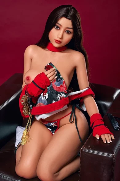 Realistic Saya 153cm E Cup Irontech TPE doll in red and black outfit on chair against dark red background