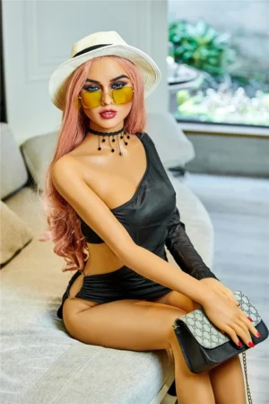 Selina 165cm A Cup Irontech TPE doll on sofa wearing black dress, sunglasses, chic hat, holding purse.