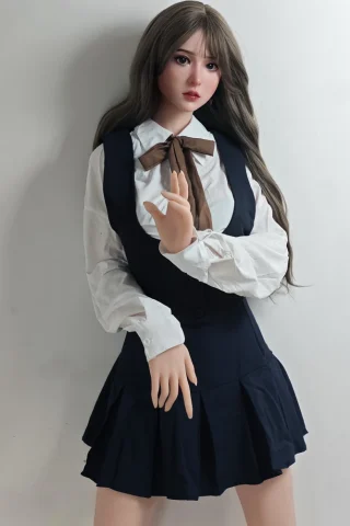 Yoshizawa Anri 165cm wearing a white blouse and dark skirt, posing with one hand raised against a plain background.