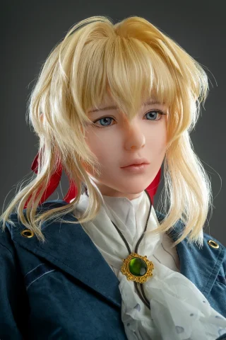 Anime.12 156cm A Cup features a doll with blonde hair, wearing a blue coat and a white scarf, with a green pendant.