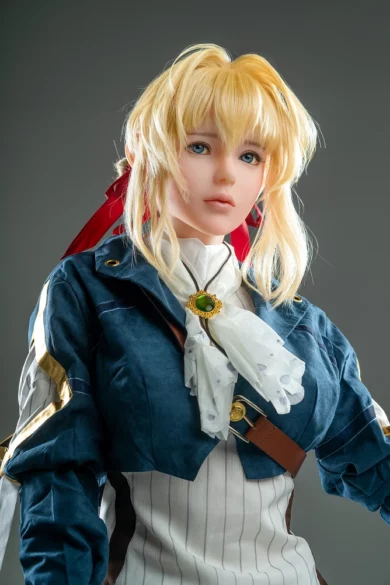 Blonde sex doll wearing a blue jacket and white ascot with a gemstone brooch, resembling an Anime character.