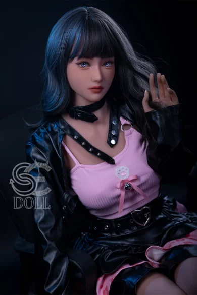 Yuuka E 158cm D Cup SE Doll with long dark hair wearing a black leather jacket and pink top against a dark background