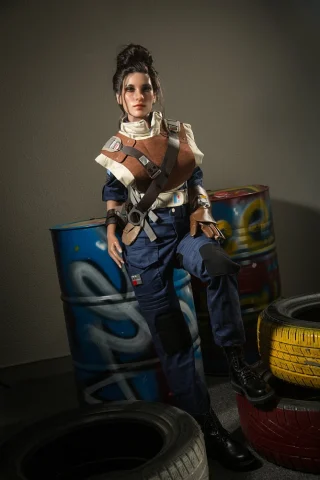 Panam 153cm doll stands confidently in a stylish outfit, featuring a brown and white top with navy pants, against a graffiti backdrop.