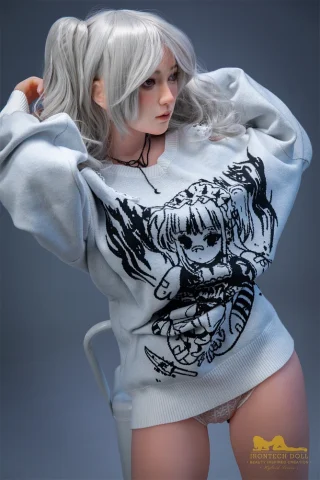 S10 154cm H Cup Irontech doll wearing a gray oversized sweater with a graphic design, posing with long silver hair.