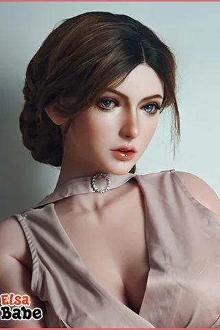 Kat Baccarin 160cm poses with a soft expression, wearing a light pink dress and a silver choker.