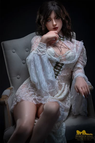 S36 163cm C Cup Irontech sex doll in white lace dress on gray chair, dark background