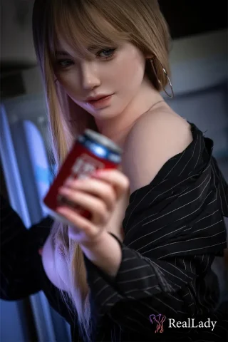 Alex S39 170cm RealLady holds a soda can while wearing a black striped shirt, with long blonde hair and hoop earrings.