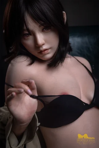 S40 163cm Irontech Doll in a black bra, with short dark hair and a neutral expression, posed against a dark background.