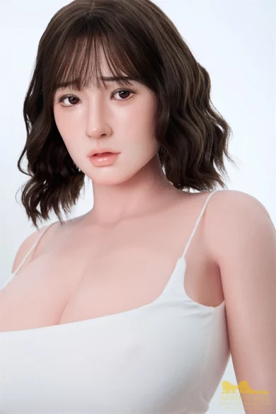 A figure with shoulder-length hair wearing a white camisole looks directly at the camera against a plain background. The S7 162cm Asian Shemale Irontech love doll captures an elegant presence and authentic gaze.