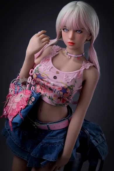 Mika.D 153cm F Cup SE#072 SE Doll standing 5ft0 tall with pink hair wearing a pink top and denim skirt holding a colorful bag