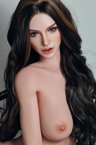 Mila Bell 160cm features long, wavy dark hair with highlights, posed with a neutral expression and bare skin.