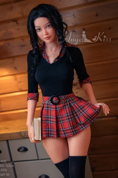 AK162 #LS34 Silicone Angel Kiss love doll in black top and red plaid skirt holding a book against wooden wall backdrop indoors