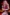 A figure in a pink wig and red costume holds a kunai knife against a blurred fiery background, similar to an Alice #038 159cm A cup love doll in a fantasy setting.