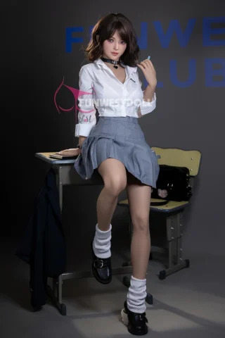 Alice #038 155cm F Cup sits on a desk wearing a white shirt and gray skirt, with black shoes and knee-high socks.
