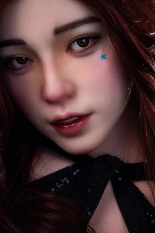 S42 163cm C Cup Natural Irontech doll with long brown hair, wearing a black outfit and a blue star makeup detail.
