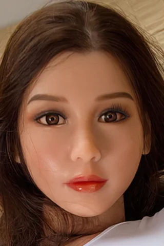 #70 WM silicone doll head with long dark hair, brown eyes, and natural makeup, resting on a light-colored surface.