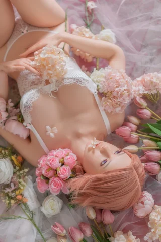 GE24 170cm C Cup Tan Zelex lies among flowers, wearing white lingerie and holding blossoms, with pink hair and blue eyes.