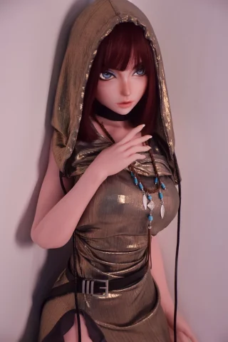 Camille Baker 148cm wearing a gold hooded dress with blue accessories, posing against a neutral background.