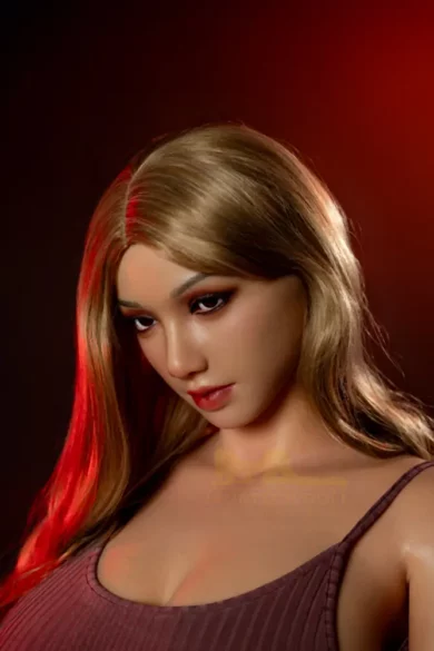 S30 Rita 160cm H Cup Irontech TPE female android with long blonde hair and an intense gaze in soft red lighting resembling a love doll