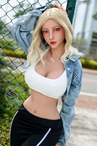 SED313 161cm Makoto doll wearing a white crop top and denim jacket, posing against a green fence.
