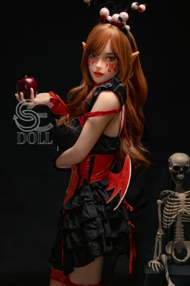 Samantha.E 158cm D Cup #022 SE Doll in red costume with wings holding an apple next to a skeleton figure