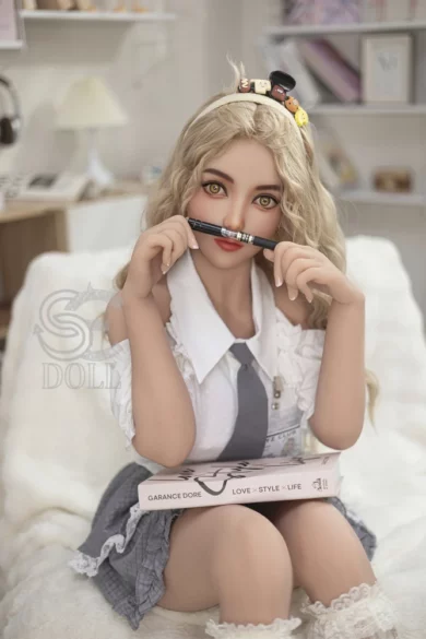 Yuuki.B sex doll with 153cm height, long blonde hair, school uniform, balancing a pen under her nose, F Cup size, book on lap.