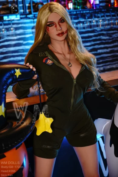 A sex doll dressed in a green outfit with pumpkin face design stands cheerfully in a lively bar setting with vibrant seasonal decor