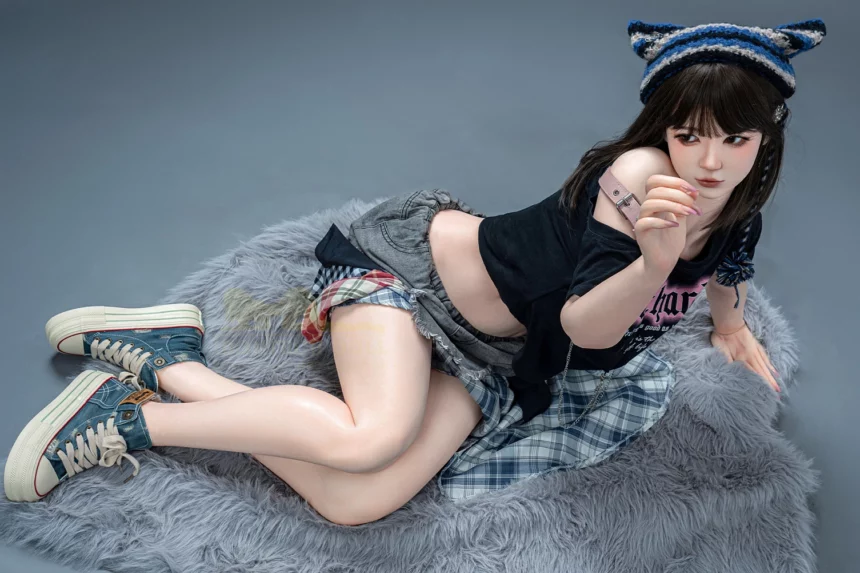 Person in black top, plaid skirt, and blue sneakers lying on fluffy gray surface in thoughtful pose