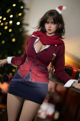 Natural Lily 157cm G Cup doll wearing a red cardigan and scarf, with a short navy skirt, posed in front of a Christmas tree.