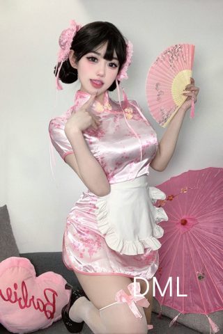 A doll wearing a pink cheongsam lingerie with floral patterns, holding a pink parasol, and a heart-shaped pillow nearby.