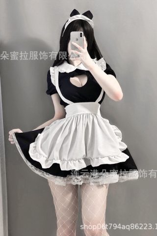 A person wearing a black and white maid costume with a heart-shaped cutout, a frilly apron, and fishnet stockings.