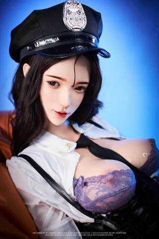 A doll dressed as a police officer, wearing a black cap and a white shirt, with a lace purple bra visible underneath. The background features a soft blue gradient.