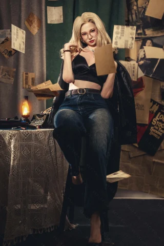 A woman with long blonde hair sits on a stool, wearing a black crop top and high-waisted jeans, surrounded by floating papers and vintage decor.